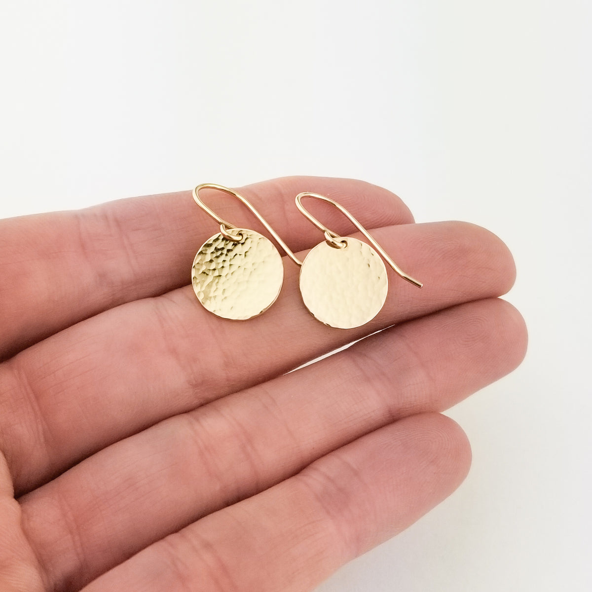 Hammered Flat Disc Earrings Solid 14 Karat Yellow Gold with 14 Karat Ear Wire Held in Hand