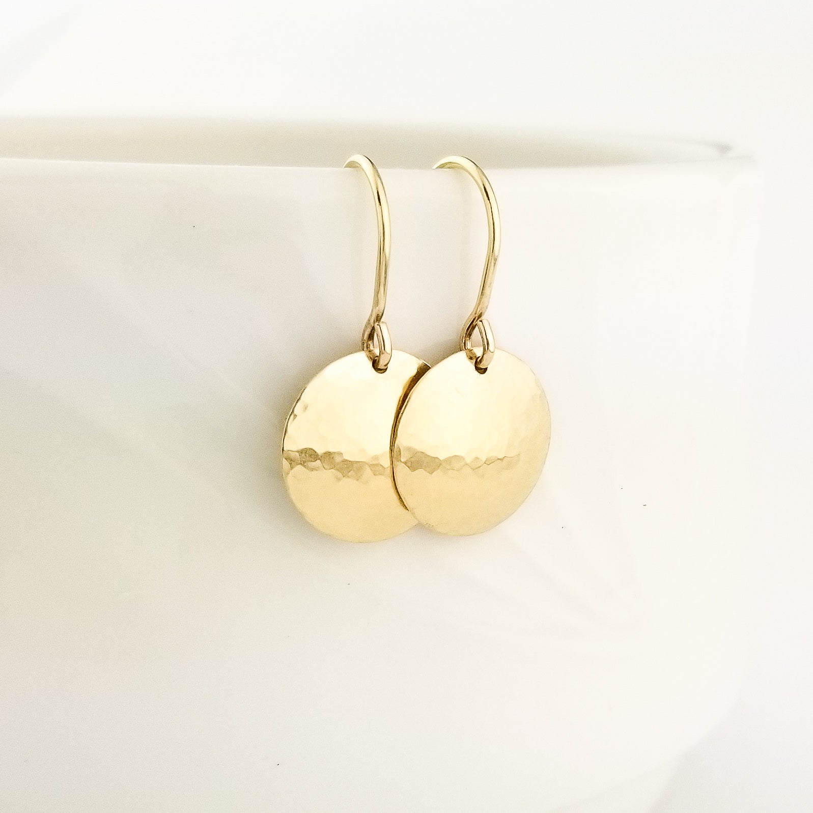 Hammered Domed Disc Earrings Solid 14 Karat Yellow Gold with 14 Karat Ear Wire Held in Hand