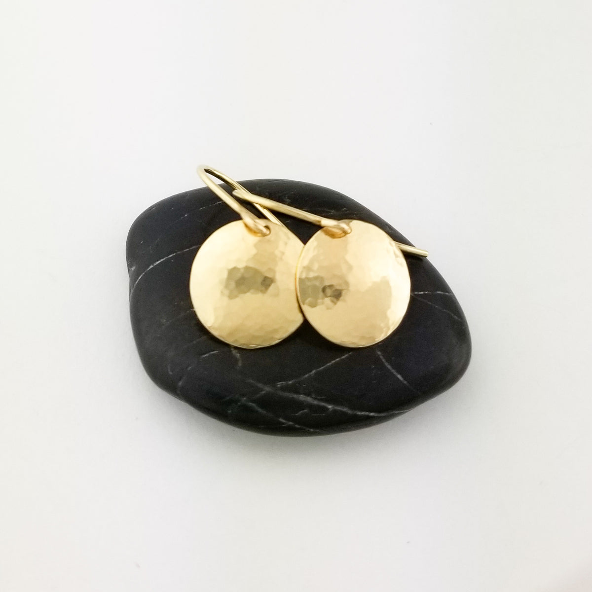 Domed Disc Earrings Hammered Solid 14 Karat Yellow Gold with 14 Karat Ear Wire on Black Rock
