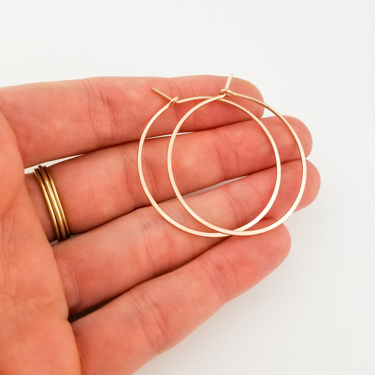 Gold Hoop Earrings in Solid 14 Karat Thick Gold Wire Held in Hand
