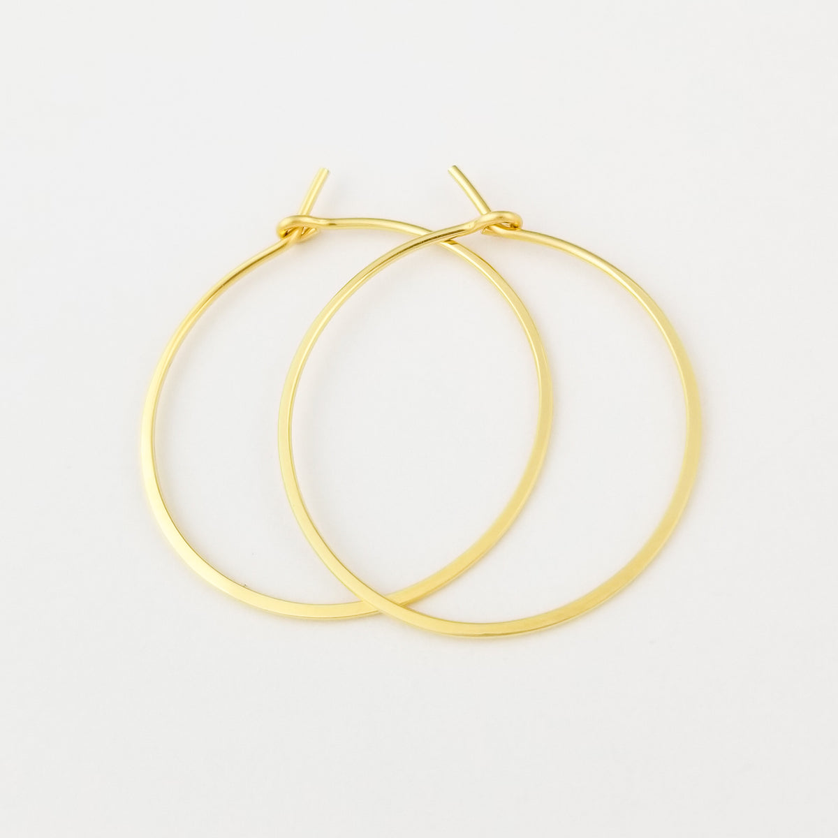 Hammered Gold Hoops Made with Solid 18 Karat Yellow Gold on White Background