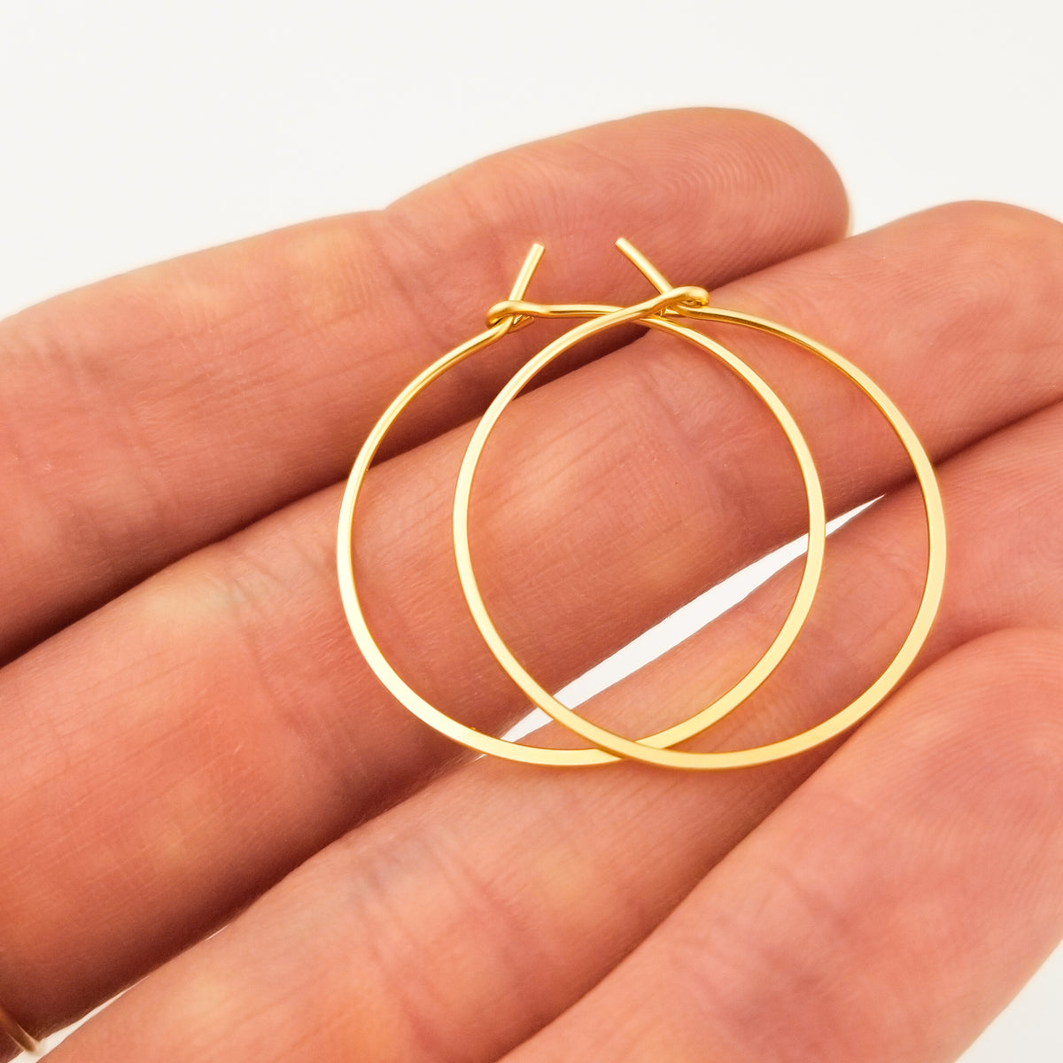 Solid Gold Hoop Earrings Hammered Flat Made from Thin Metal Wire on Hand