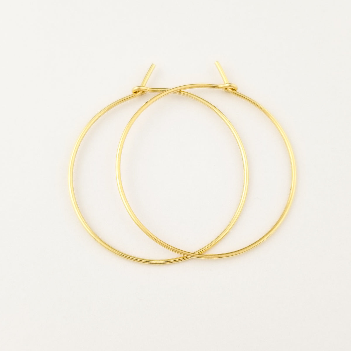 Thick Classic Solid Gold Hoop Earrings in Yellow 14 Karat Gold on White Background