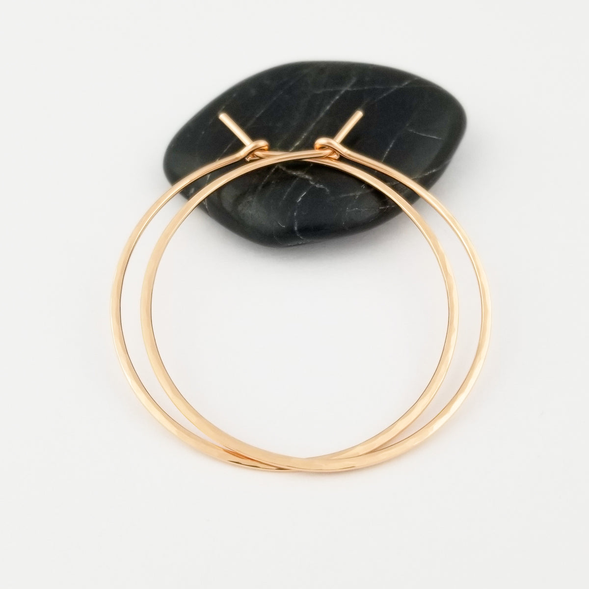 Solid 14k Rose Gold Thick Hammered Gold Hoop Earrings on Black Rock