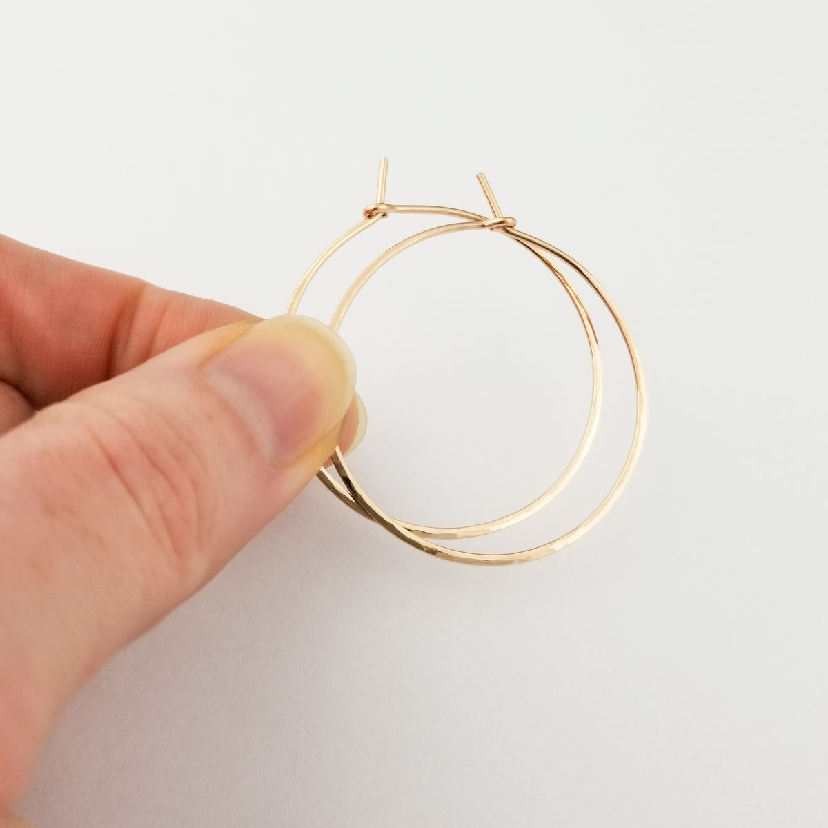 Hammered Gold Hoop Earrings in Solid 14k Rose Gold Thick Metal Wire Held in Fingers